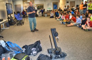 Students in a Science, Technology, Engineering and Mathematics (STEM) class at Discovery Middle School watch an FBI bomb expert demonstrate a robot. (CONTRIBUTED) 