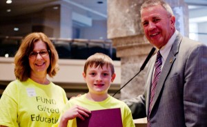 West Madison Elementary School gifted specialist Wendy Tibbs and fifth-grader Dylan Harbour receive West Madison's resolution read to the Alabama House of Representatives from Rep. Mac McCutcheon. (CONTRIBUTED)