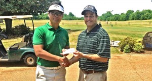 Moon Kang, at left, accepts the prize check for winning the Optimist Junior Golf Tournament from Optimist Richard Cooper. (CONTRIBUTED) 