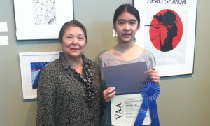 Discovery Middle School art teacher Raquel Spiegel, at left, congratulates Victoria Lee as first-place winner in Alabama Pharmacy Association's Poison Prevention Art Contest. (CONTRIBUTED) 
