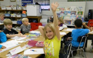 At New Hope Elementary School, a student raises her hand to ask a question. The school recently won a video award from the Alabama Community Education Association. (CONTRIBUTED) 