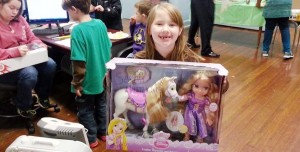 A girl beams about her "My Little Pony" at a local Boys and Girls Club. An auto auction on June 23 will benefit the clubs. (CONTRIBUTED) 