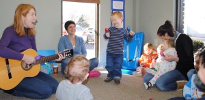 A toddler group enjoys guitar music at The Arc of Madison County, which won Regions Bank's "What a Difference a Day Makes" contest. (CONTRIBUTED) 