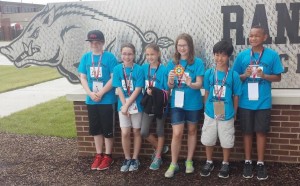 The Heritage Elementary School Robotics Team, named 15 Percent, stands at the track center on the University of Arkansas campus. (CONTRIBUTED) 