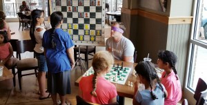 During Girls' Chess Night on July 20, International Master Danny Rensch played three games against teams while he was blindfolded. (Contributed/Ranae Bartlett) 