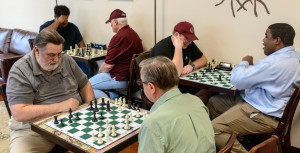 Chess players at Grounded Coffee on a typical Tuesday night are Florence residents Jack Gardner, foreground from left, and Tom Lotito and Madison residents Richard Gross, background from left, Paul Mulqueen, Noel Newquist and Undrea Randolph. (Photo by Scott Wilhelm)