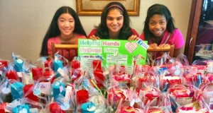 Helping Hands Hygiene Drive organizers Tinnie Louie, from left, and Michelle Abreo, along with friend and volunteer Alanna Robinson, inspect 'care packages' that they distributed at Manna House. (CONTRIBUTED) 