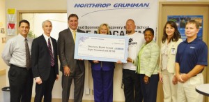 STEM Academy teacher Julia West, center, accepts Northrop Grumman's donation for a Greenpower car at Discovery Middle School. Northrop officials joined Mayor Troy Trulock, Discovery Assistant Principal Kim Stewart and coordinator of secondary instruction Dr. Heather Donaldson for the presentation. (CONTRIBUTED)  