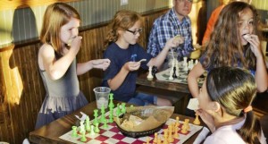These chess players break for snacks during Girls Chess Night, which is starting a tour of Madison schools. (CONTRIBUTED) 