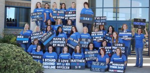 Wearing theme T-shirts and holding original posters, members of North Alabama Police Wives met at the Fallen Officers Memorial in Huntsville recently to show support for their husbands. (Contributed/Melanie Kolowski Photography)