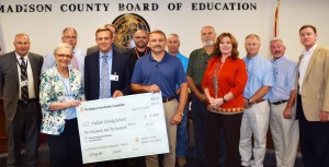 Madison County Schools Superintendent Matt Massey accepts $10,500 from the Alabama Home Builders Association for the plumbing and pipefitting program. (CONTRIBUTED) 