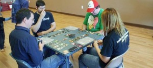 Madison Martial Arts Academy is hosting "Extra Life 2015" on Nov. 7-8 to benefit Children's Miracle Network Hospitals. In this photo, Dannie Luvall, Richard William Watts, Brian Wood and Morgon Newquist play Race for the Galaxy at the 2013 event. (CONTRIBUTED) 