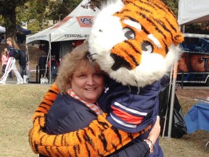Mary Beth Jernigan gives a big hug to Aubie, Auburn University's mascot. (CONTRIBUTED) 