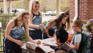 At Heritage Elementary School, students buy donuts from the "Jettes," James Clemens High School Band dancers, to raise funds for St. Jude Children's Research Hospital. CONTRIBUTED
