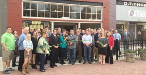 Owners Todd and Dawn Seaton, with scissors, cut the ribbon to Old Black Bear Brewery, Taproom, Coffee Shop and Kitchen at 212 Main St. in downtown Madison. RECORD PHOTO/ALAN BROWN 