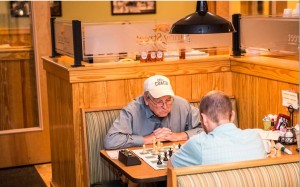 Space City Chess Club Manager Don Maddox, at left, prepares for the third Sunny Street Cafe Chess Grand Prix with Josh McClellan. CONTRIBUTED