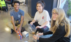 Junior Trevor Stewart, from left, senior Masi Barnes and sophomore Gracie Poehlman and classmates in multimedia design made Pack-A-Care kits. These Bob Jones High School students also write for "Patriot Pages." CONTRIBUTED