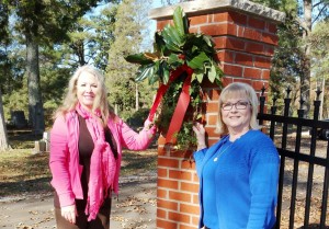 Jeanne Steadman, at left, and Cindi Sanderson with Madison Municipal Cemeteries Committee placed evergreen swags for Christmas at Madison's three cemeteries. CONTRIBUTED