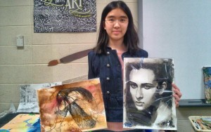 Victoria Lee at Discovery Middle School shows two of her award-winning pieces of art. CONTRIBUTED