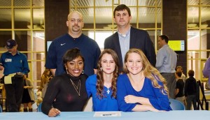 Coaches Aaron James (top left) and A.J. Daugherty helped Jets players Aubrion James, Emily Jackson and Caroline Payne celebrate signing softball scholarships. RECORD PHOTOS/MIKE EASTERLING