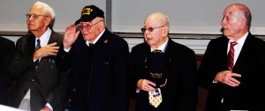Sherwin Callander, second from left, salutes during the ceremony with the French Consul in Montgomery when he and other World War II veterans received France's Legion of Honor award. CONTRIBUTED