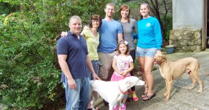 Lila Kalnajs' family includes son-in-law Ryan Galloway, from left, Lila, son Kon Kalnajs, Kon's fiancee Jenny Woyak, daughter Maija Kalnajs Galloway and, in front, granddaughter Zane Galloway. Both rescued, their pets are Wendy, a white greyhound, and Marty, a tan Viszla. Not shown is Lila's husband, Andrejs Kalnajs. CONTRIBUTED
