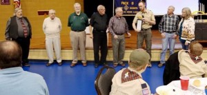 Optimist President Scott Piro, fifth from left, presents $500 to Pack 8 Scoutmaster Jonathan Frazier. Optimists Jim Cook, from left, Tony Miele, Mike Doyle, Charlie Brown, Vic van Leeuwen and Ann van Leeuwen also attended. CONTRIBUTED