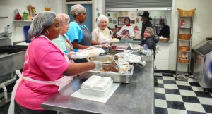 At Madison Senior Center, Andrea Rogers, Barb Mills, nutritionist LaWanda Mason, Robbie Norman and Joey Cook plate lunches. Lyn Randolph is taking her meal at the window, with Elsworth Walton and Lena Coney in line. CONTRIBUTED.