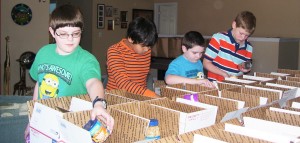 Youth at Madison Church of Christ pack 'spring care' boxes for deployed soldiers. Volunteers are Wesley Ridenour, from left, Liberty Middle School seventh-grader; Vishal Rameshbabu and Andrew Ridenour, both Mill Creek Elementary School fourth-graders; and Alex King, Mill Creek sixth-grader. CONTRIBUTED