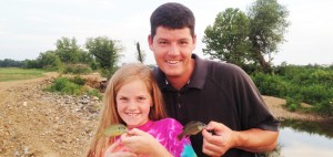 Tom Runnion and daughter Parker compare their catches on a fishing trip. He is Bob Jones High School's Teacher of the Year. CONTRIBUTED