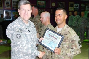 Major General Steven W. Smith presents a Certificate of Wartime Service to Waldemar Ramirez, who was Chief Warrant Officer 2 at the time, in Kuwait during the Operation Enduring Freedom's campaign in 2012-2013. CONTRIBUTED 