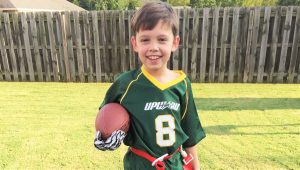 Prepared with all of his game gear, Zachary Ellenburg is ready to play a game of Upward football. 