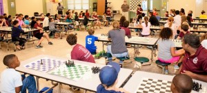 Coach Noel Newquist and Executive Director Ranae Bartlett with Madison City Chess League, front center, speak at the 2015 Learn to Play Chess Night. CONTRIBUTED
