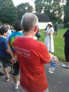 A man wearing a "Madison Ghost Walk" T-shirt listens intently with other walkers as Jacque Reeves discusses the eerie side of Madison's history. RECORD PHOTO/GREGG L. PARKER 