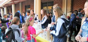 At Heritage Elementary School, numerous students crowd to buy donuts from James Clemens dancers, the Jettes. Proceeds will benefit St. Jude Children's Research Hospital. CONTRIBUTED/Marcia White