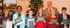 Madison Garden Club honored these students as top writers in the "What Peace Means to Me" contest. Tommy Overcash, President of Madison City Council, congratulates them. CONTRIBUTED