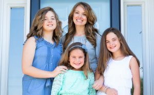 Sharon Webber, at center, stands with her daughters Olivia, from left, LeighAnne and Lauren. CONTRIBUTED