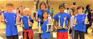Dorinda White, Principal at Rainbow Elementary School, congratulates Math Team students after a competition in 2016. CONTRIBUTED